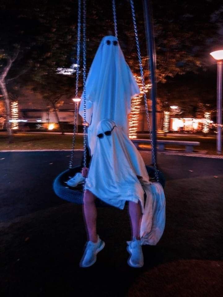 a man in a dress on a swing
